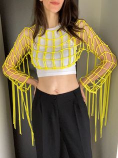 Yellow Macrame Top - a festival must-have, perfect for Tomorrowland, beach parties, Burning Man, and Coachella. This vibrant yellow outfit is designed to make you stand out with style at any party or music festival. Information: * Material: polyester cord. * Color: yellow - ready to ship.  * Size: s-m. * Handmade by myself in Lithuania, Europe. * Size s-m in yellow is ready to ship. For other sizes or other colors - please contact me by messages here on Etsy.  Care recommendations: hand-wash only with soup, no tumble dry, lay the garment out to dry on the flat surface, like a sofa, table or countertop. Shipping: ready to ship item will be dispatched in 1-3 business days. Made to order items may take additional 3-7 business depending on cord availability and your request details.  Worldwide Summer Party Crop Top With Fringe, Summer Stretch Fringe Tops, Fitted Crop Top For Beach Party In Spring, Summer Party Cropped Crochet Top, Spring Fringe Crop Top, Cropped Crochet Top For Summer Parties, Bohemian Crochet Top For Spring Party, Spring Party Crochet Top, Rave Crop Top For Spring Party