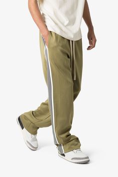 the Relaxed Tricot Track Pants are designed with a custom-developed, 300 GSM single-layer tricot fabric, featuring a contrasting striped panel down the side leg and an extended drawcord details relaxed fit 65% polyester 35% cotton custom developed heavyweight tricot fabric model is 6’1, 160 lbs and wears a size medium Striped Straight Leg Bottoms For Streetwear, Striped Straight Leg Pants For Streetwear, Striped Cotton Pants For Streetwear, Sporty Straight Sweatpants With Side Stripes, Athleisure Pants With Contrast Stripes For Spring, Spring Athleisure Pants With Contrast Stripes, Sporty Cotton Pants With Three Stripes, Cotton Sweatpants With Side Stripes For Jogging, Relaxed Fit Sports Pants With Contrast Stripes