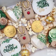 an assortment of decorated cookies with gold, green and white decorations