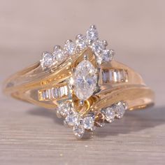 a close up of a gold ring with diamonds on the top and bottom, sitting on a wooden surface