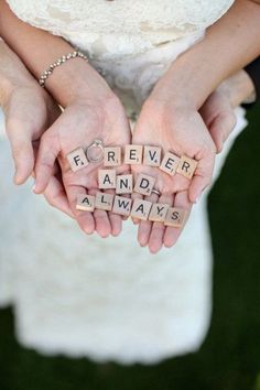 two hands are holding scrabble letters that spell out the word forever and always