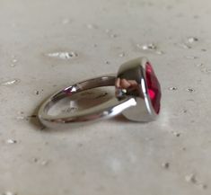 "A Classic oval shaped Faceted Lab Created Ruby Sterling Silver Ring featuring a comfort fit band with a bezel around the stone. This makes a great birthstone ring for those July Birthdays! Wrapped in a box ready for gift giving.(r-537) RING INFO ---------------- STERLING SILVER Stone with Bezel measure 11.5mm x 10mm July BIRTHSTONE *Follow us @belesasjewelry on Instagram for promotions/giveaways *LIKE* us on Facebook http://www.facebook.com/Belesas *If you like the ring, please click on the \"P Adjustable Red Oval Ruby Ring, Adjustable Oval Red Ruby Ring, Red Round Ring For Everyday, Everyday Red Round Ring, Modern Oval Ruby Ring With Bezel Setting, Red Oval Stackable Promise Rings, Red Bezel-set Round Band Rings, Red Ruby Ring With Bezel Setting, Red Oval Ring With Bezel Setting