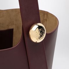 Burgundy colour calfskin leather medium bucket bag from Loewe featuring a magnetic closure, an adjustable shoulder strap via a gold-tone button with an engraved Anagram logo, an internal flat pocket and gold-tone metal hardware. Width 24,5 cm x Height 28 cm x Depth 23,5 cm Adjustable shoulder strap length min 40 cm - max 106 cm Size Type: INTMaterial: LeatherSKU: AANBBBWX01LE/P_LOEW-7240_100 Burgundy Colour, Medium Bag, Burgundy Color, Medium Bags, Metal Hardware, Bag Women, Gold Tone Metal, Magnetic Closure, Easy Access