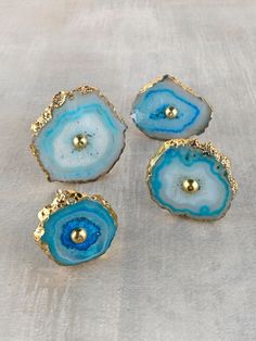 three pieces of blue agate with gold accents