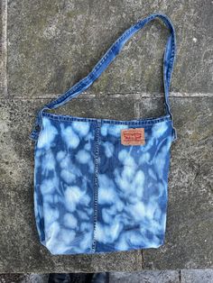 Large tote bag handmade from a pair of authentic Levi's jeans. Reworked by hand with the waistband as the handle, this is a useful and one of a kind accessory that will fit lots in - from your laptop to your groceries. Abstract dye print. Finished off with the Levi's leather tab sewn on the front and frayed edges. SIZE: Approx 40cm by 45cm Any questions please ask :) Blue Cotton Bucket Shoulder Bag, Upcycled Medium Wash Cotton Shoulder Bag, Upcycled Dark Wash Cotton Bag, Upcycled Cotton Bag, Casual Indigo Cotton Bag, Reworked Denim, Denim Tote Bags, Denim Tote, Tote Bags Handmade