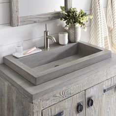 a bathroom sink sitting on top of a wooden cabinet