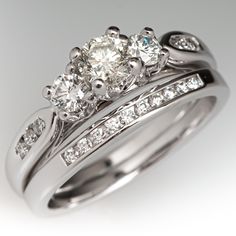 a couple of rings that are sitting on top of each other with diamonds in them