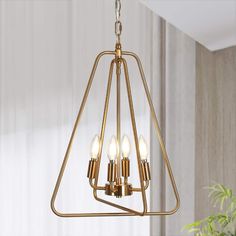 a brass chandelier with four lights hanging from it's center triangle shape