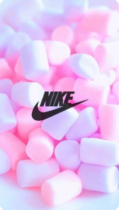 pink and white marshmallows with the nike logo on them are scattered together