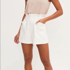 The Paperbag Shorts Come In White And Tan. They Have An Elastic Waist With A Front Zipper. These Are Perfect For A Classy Brunch Or Dinner. Definitely A Staple For Everyones Closet Model Is 5’4 And Wearing Size Small Paperbag Waist Bottoms With Built-in Shorts For Day Out, Versatile Short Bottoms For Day Out, Versatile High-waisted Shorts For Summer, Versatile Summer Shorts For Day Out, Versatile High-waisted Shorts For Day Out, Versatile Short Length Bottoms For Day Out, Versatile Summer Shorts With Pockets, Versatile Shorts With Pockets For Day Out, Versatile High Waist Shorts For Day Out