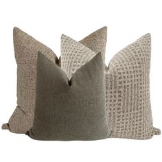 two gray and white pillows sitting next to each other