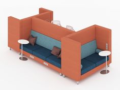 an orange and blue couch sitting next to two tables