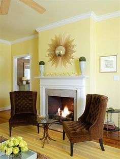 a living room filled with furniture and a fire place in the middle of the room