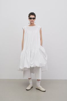 Sleeveless balloon dress in heavyweight fine cotton poplin with gathered hem, structured shoulders, silk-lined side seam pockets, and attached slip lining for added volume. Overalls Runway, Ganni Aesthetic, Balloon Hem Dress, Sculptural Dress, Modular Fashion, Balloon Dress, Fashion Silhouette, Mumu Dress, Aesthetic Board