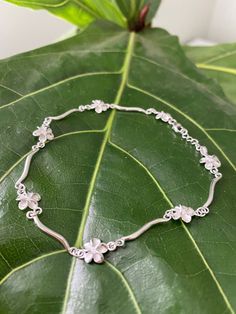 "PLUMERIA STERLING SILVER ANKLET This genuine 925 sterling silver anklet features the plumeria flower. Makes a great gift or addition to your Hawaiian jewelry collection. Material: 925 STERLING SILVER Length available: 9\" or 9.5\" Closure: Lobster Clasp Quantity: 1 Bracelet" Hawaiian Jewelry, Sterling Silver Anklet, Silver Anklets, Jewelry Lookbook, Anklet Jewelry, Body Jewelry, Anklets, Beautiful Rings, Silver Necklace