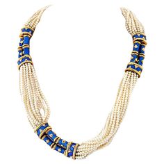 Tiffany & Co., Schlumberger Multistrand Cultured Pearl, Gold and Blue Paillonné Enamel Torsade Necklace, France. 18 kt., composed of twenty-three strands of pearls ap. 2.8 to 2.6 mm., spaced and completed by three stations of four blue paillonné enamel cylinder links applied with polished gold diamond-shaped plaques, flanked by bombé bar links of similar motif, all edged by polished gold, signed Tiffany, Schlumberger, Made in France, with French export marks. Pearls: very slightly creamy with st Luxury Blue Pearl Drop Necklace, Luxury Blue Pearl Necklace, Tiffany Schlumberger, Diana Vreeland, Elsa Schiaparelli, David Webb, Gold And Blue, Tiffany And Co, Van Cleef Arpels