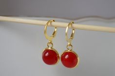 Red jade earrings, Small gemstone gold plated pendant huggie earrings, Lever back, 10mm, Red stone hoop earrings, Red, Jade jewelry, Gift for women. ⭐ Handmade beautiful gemstone Red Jade Earrings. ⭐ Materials used:-   Earrings  * Semiprecious gemstone jade red cabochons, jewelry glue, * 10mm/ 12mm gold plated stainless steel pendant,  * Huggies hoop earrings Material and size:- 304 stainless steel lever back hoop earrings measures 14.5 x 12 mm ⭐ Also other designs for jade jewelry and all gemst Red Gemstone Hoop Earrings Gift, Red Stone Earrings, Red Hoop Earrings, Stone Hoop Earrings, Red Jade, Handmade Jewelry Earrings, Earrings Round, Jade Earrings, Earrings Red