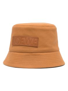 caramel brown cotton/canvas flat crown leather logo patch to the front dropped narrow brim full lining pull-on style This piece comes complete with a protective dust bag. This item is in size 58 and the color is Beige Designer Brown Hat With Short Brim, Classic Brown Bucket Hat With Flat Brim, Classic Brown Bucket Hat With Short Brim, Brown Cotton Hat With Logo Patch, Designer Brown Hat With Embroidered Logo, Brown Cotton Bucket Hat With Curved Brim, Brown Cotton Bucket Hat With Short Brim, Classic Brown Hat For Streetwear, Brown Flat Brim Hat With Embroidered Logo