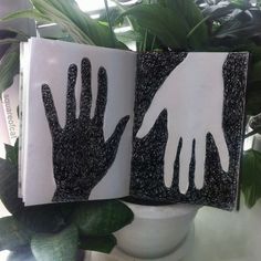 two handprints are placed next to each other in front of a potted plant