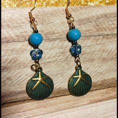 Adorable Long Dangle Earrings Featuring Aqua Blue & Rhinestones Beads With Antique Gold Tone Accents Antique Bronze No Rust Sea Shell Charm Earring Attaches To A Standard Hypo-Allergenic Fishhook Fitting Handmade, Nwot, Never Worn, Some Elements Upcycled From Vintage Pieces Smoke Free / Pet Free Environment This Item Qualifies For 10/$10 Offer! Blue Dangle Earrings For The Beach, Blue Metal Beaded Drop Earrings, Blue Metal Beaded Dangle Earrings, Blue Dangle Earrings With Ocean-inspired Style, Blue Metal Beaded Earrings For Pierced Ears, Ocean-inspired Blue Dangle Earrings, Blue Metal Jewelry For Beach, Metal Beaded Drop Earrings For Beach, Beaded Metal Drop Earrings For Beach