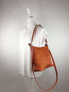 This leather purse for women in luminous cognac brown with top zipper and 2 interior sleeves is made of high quality pull up cow leather. It is convertible and and it has 2 straps, a long crossbody strap and a thicker short shoulder strap. It is an every day handbag, and you can use it for travel, work, city trip, shopping and more. It has an effortless style and is suitable for many outfits. Size: 12" wide, 11" high, 4.5" deep Weight: 28 oz (0,8 kg) Color: luminous cognac brown Material: High q Cognac Leather Strap Crossbody Shoulder Bag, Brown Leather Strap Satchel For On-the-go, Brown Leather Strap Satchel, Brown Leather Strap Shoulder Bag For On-the-go, Purse For Women, City Trip, Pull Up, Leather Purse, Leather Handbag