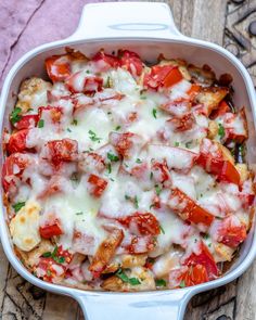 a casserole dish with tomatoes and cheese