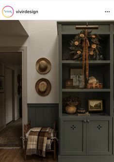 a green bookcase with two hats on top of it