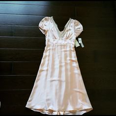 This Apricot Dress Has Never Been Worn. There Is One Little Black Line On The Back Of The Dress As Shown In The Last Picture. Would Probably Come Out With Dry Cleaning. Dress Is Lined And Has Back Zipper. Outer Shell Is 100% Silk. I'm 5'6" And Dress Hits A Few Inches Above The Ankle. Feminine Silk Knee-length Mini Dress, Feminine Knee-length Silk Mini Dress, Feminine Silk Mini Dress With V-neck, Spring Party Silk Dress With V-neck, Fitted V-neck Silk Dress For Daywear, Fitted V-neck Silk Dress For Cocktail, Empire Waist Mini Dress For Spring Party, Feminine Fitted Silk Knee-length Dress, Feminine V-neck Silk Dress For Spring