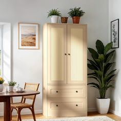 a room with a table, chairs and a cabinet in the corner that has potted plants on top of it