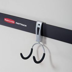 a pair of scissors is hanging on the wall next to a fastrack sign