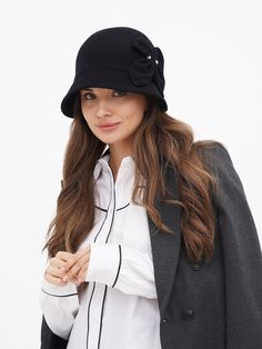 Discover the timeless elegance of our Women's Winter Cloche Hat, a perfect blend of classic style and modern comfort. Inspired by the iconic flapper era, this wool hat is a nod to the glamorous Gatsby days, bringing a touch of vintage charm to your wardrobe. Available in two sophisticated colors - classic black and a deep, dark blue - this hat is designed to complement any outfit, whether you're dressing up for a special occasion or adding a stylish accent to your everyday wear. Crafted with the highest quality wool, our cloche hat promises not only style but also warmth and comfort during the colder months. The wool fabric is carefully selected for its softness and durability, ensuring that the hat maintains its shape and elegance over time. The snug fit of the cloche design is both pract Luxury Wool Brimmed Cloche Hat, Luxury Brimmed Wool Cloche Hat, Luxury Casual Brimmed Cloche Hat, Luxury Flat Brim Cloche Hat For Winter, Luxury Vintage Cloche Hat With Flat Brim, Luxury Vintage Cloche Hat With Curved Brim, Luxury Wool Classic Cloche Hat, Chic Luxury Cloche Hat For Women, Luxury Classic Cloche Hat With Curved Brim