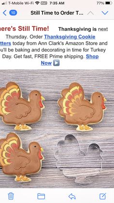 three turkey cookie cutters sitting on top of a wooden table next to each other