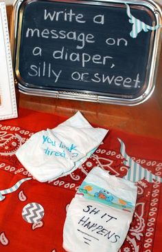 a baby's diaper is sitting on a table next to a sign that says write a message on a paper, silly orsweet