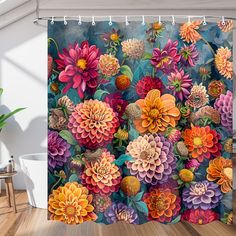 a shower curtain with colorful flowers on it in a room next to a potted plant