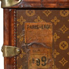 an old suitcase with the word paris - l'on it is shown in gold and brown