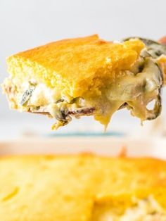 a piece of food is being lifted from a casserole dish by a fork