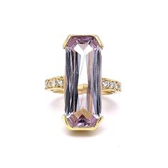 Elongated Kunzite & Diamond Cocktail Ring in 18k Yellow Gold This dazzling Elongated Kunzite & Diamond Cocktail Ring in 18k Yellow Gold is a statement ring to remember! The center kunzite weighs an impressive 14.69 carats and reflects a soft lavender / jacaranda hue.  The gemstone is emerald cut and set thick channel-style protective prongs. Ten (10) bright near colorless accent diamonds sparkle at the shoulders of the band. Modern & stylish. Colorful gemstone Kunzite Jewelry will have you turni Kunzite Jewelry, Soft Lavender, Platinum Rose Gold, Diamond Cocktail Ring, Sapphire Solitaire, Metal Shop, Diamond Cocktail Rings, Shop Engagement Rings, Cocktail Ring