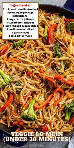 a pan filled with noodles, broccoli and peppers