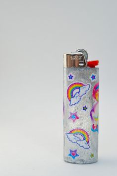 a flask shaped lighter with rainbows and stars on it