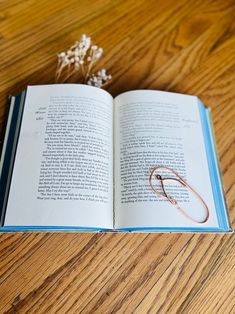 an open book sitting on top of a wooden table