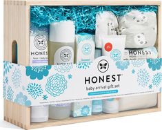 the honest baby gift set is in a wooden box with blue flowers and white packaging