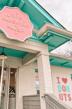 the front entrance to five daughters bakery with an awning over it's door