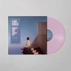 a pink and purple vinyl album with an image of a woman sitting on stairs