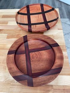 two wooden plates sitting on top of a cutting board