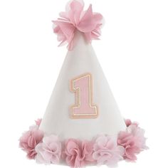 a pink and white birthday hat with the number one on it