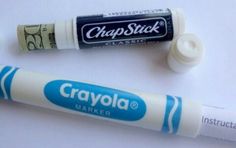 two crayola markers are sitting next to each other on a white table top