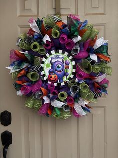 a colorful wreath is hanging on the front door