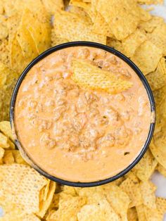 a black bowl filled with salsa and tortilla chips