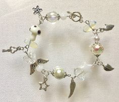 This lovely bracelet is 7 inches in length, and is made up of acrylic, opaque, lampwork and pearl beads with opal chip stones and silver tone charms. Enclosure is toggle, but you may opt to request for a lobster claw with 1 inch extender. A versatile bracelet to match your outfit! Always made with love, love, love! <3 White Fairycore, Accessories Tutorial, Cottagecore Y2k, Kawaii Bracelet, Star Cartilage Earring, Y2k Kawaii, Fairycore Cottagecore, Edgy Jewelry, Angel Charm