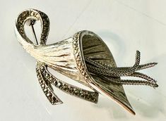 Rare ladies dazzling signed 1950's sphinx open lilly  styled silver plated brooch pre owned in excellent condition  with an open head attached to a bow like stem , highlighted with marcasite stones  from inside the head of the lilly a 4 fine free dangling silver chains to replicate the  stamen  with detail cuts inside the head fully working pin , has been steam cleand  very stylish art deco formed , a lovley gift  size.  6 x 3 cm  weight 10.5 grms Stylish Art, A 4, Brooch Pin, Brooches, Silver Chain, Silver Plate, Silver Plated, Art Deco, Bathing Beauties